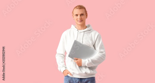 Young man with laptop on pi...