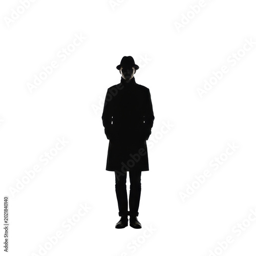Silhouette of a Person in a Coat and Hat, Mysterious and Dark isolated on white background