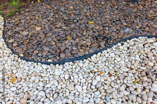 Cuadro en lienzo Garden Edging Border or Rubber garden edging in demarcating garden areas, helping to prevent  grass, and stones from sliding off the property