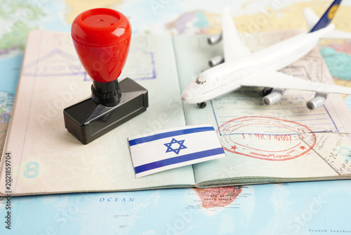 Israel flag and passport with airplane for travel.