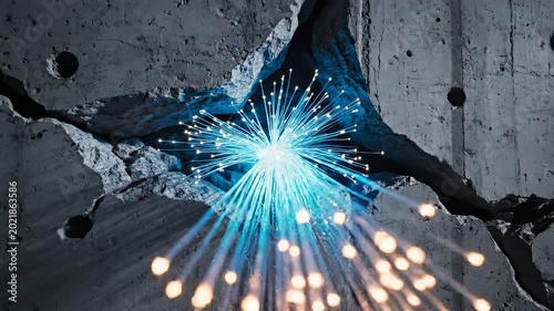 A bright blue light shines through a cracked concrete wall with sparks flying.