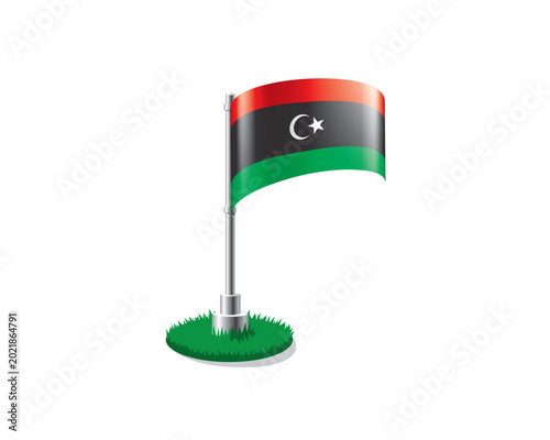 Bild auf Leinwand Libyan flag on a flagpole mounted on the grass