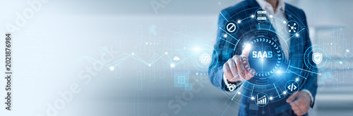 Fotografie Software specialist pointing at SaaS and networking cloud software systems, subs