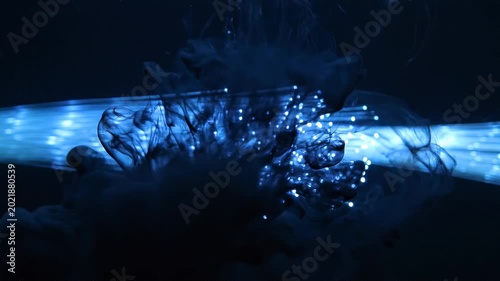 Glowing blue lights on a dark background with abstract shapes and patterns.