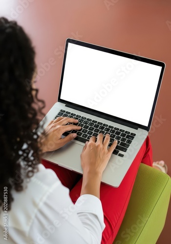 Young Woman Working on Laptop with Blank White Screen Mockup, Over the Shoulder View of Ha