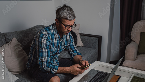 Remote worker using smartphone during overtime