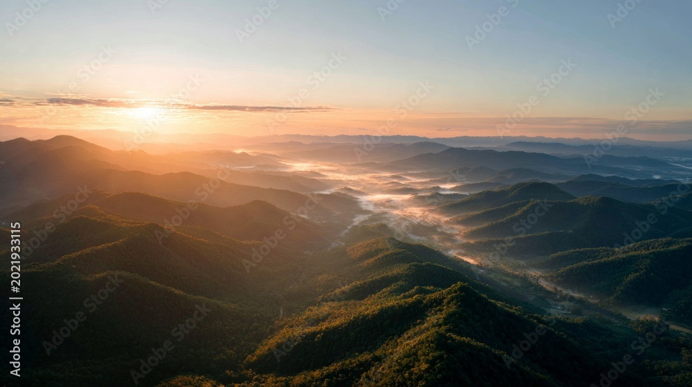 Fototapeta premium Sunrise over mountain range with warm golden light, cinematic drone style wide shot, realistic 