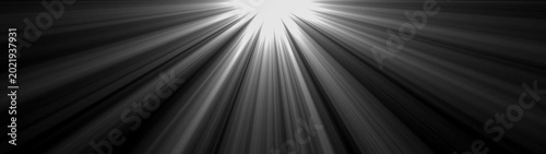 Foto Light beams emanating from bright source in darkness abstract background