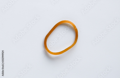 Quadro su tela Close-up of one stretchy elastic rubber band lying on a plain white surface