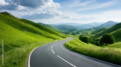 Scenic winding road through lush green rolling hills