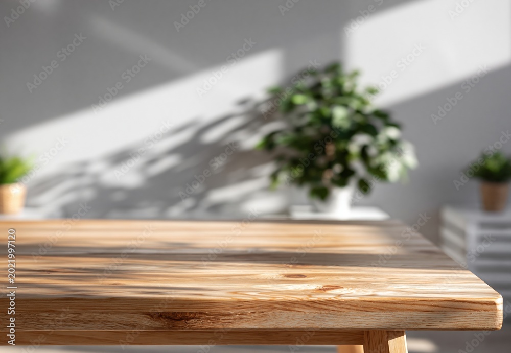 Fototapeta premium Wooden Tabletop Surface with Sunlight Shadows and Green Houseplants in Background