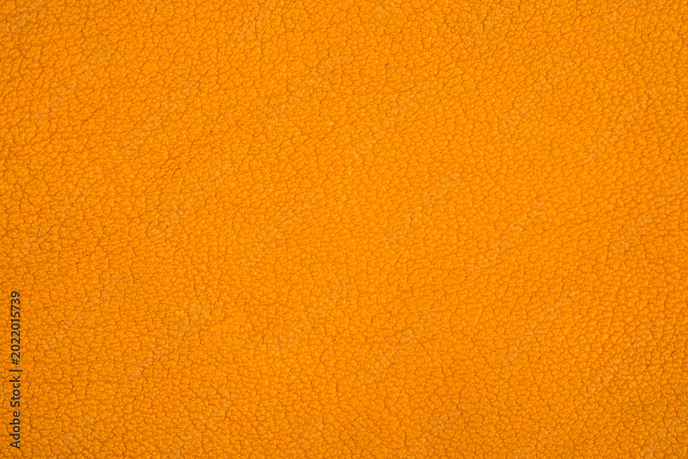 Fototapeta premium Orange fuzzy fabric texture close up