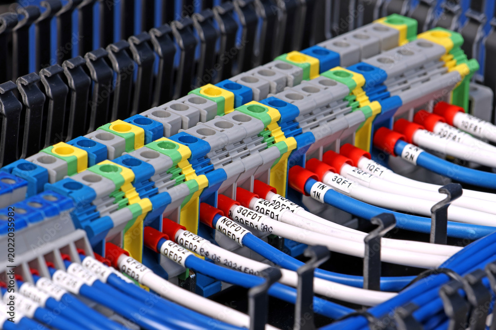 Fototapeta premium Electrical screw terminals for connecting copper electrical wires with metal lugs in electrical switchboard. 
