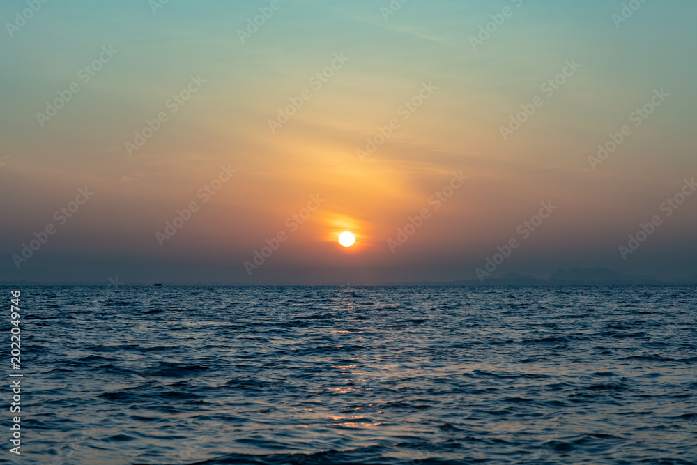 Fototapeta premium Morning sunrise views from a speeding longtain boat over the Andaman Sea, offshore of Krabi, in southern Thailand. 