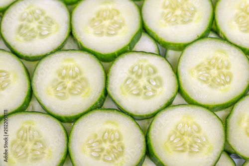 Fotografie Cool cucumber slices symbolize hydration therapy, bright pale interiors and gree