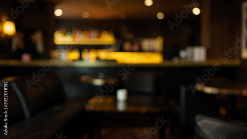 Upscale lounge bar interior with warm ambient lighting and comfortable seating