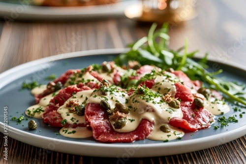 Vitello tonnato with tuna sauce, capers, and arugula
