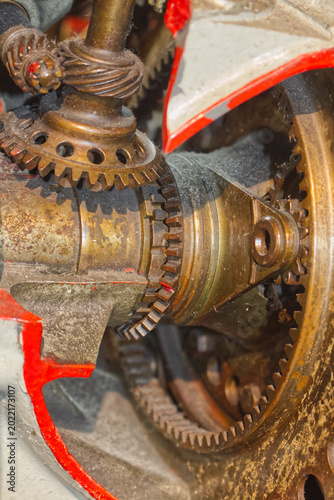 Close-up of complex interlocking metal gears in a heavy industrial engine. Mechanical engineering background
