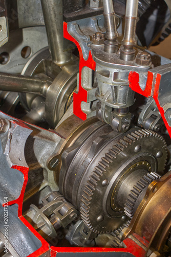 Close-up of complex interlocking metal gears in a heavy industrial engine. Mechanical engineering background