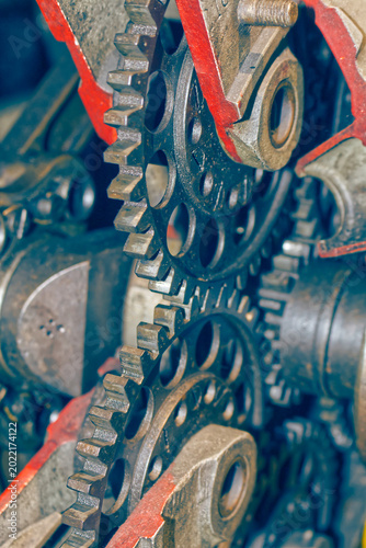Detailed view of interlocking metal cogs and gears in a mechanical device. Industrial engineering