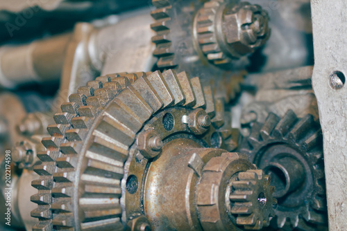 Close-up of complex interlocking metal gears in a heavy industrial engine. Mechanical engineering background