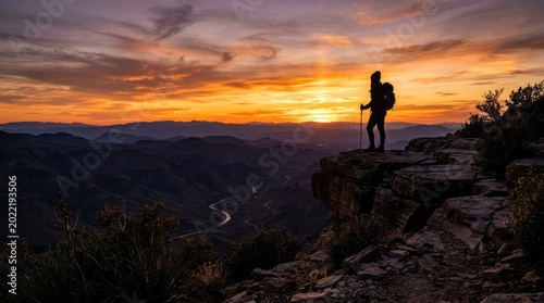 Hiker Silhouette at Sunset Over Mountains