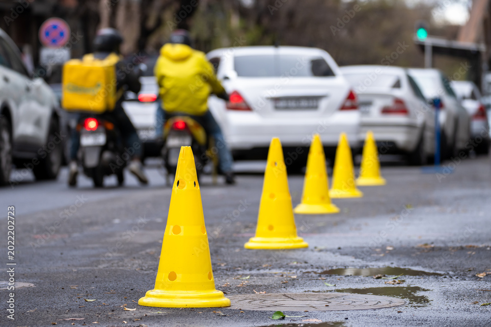 Ταπετσαρία Road with cones marking a closed or restricted section, indicating traffic control, construction work, safety precautions, and temporary urban road management
