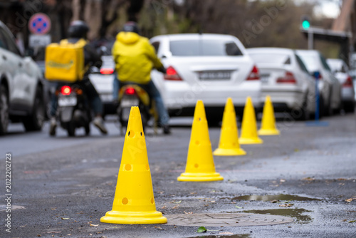 Quadro su tela Road with cones marking a closed or restricted section, indicating traffic control, construction work, safety precautions, and temporary urban road management