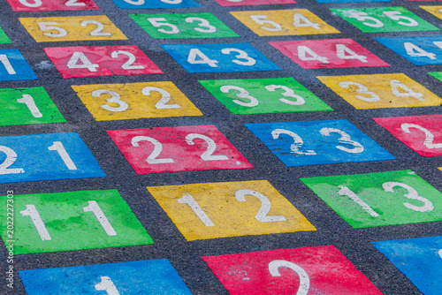 Bilde på lerret Colorful numbered squares painted on asphalt, resembling a hopscotch grid