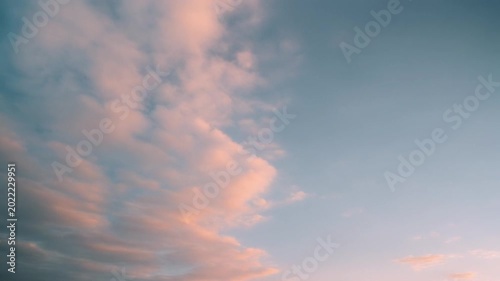 wide pastel-colored clouds in sky, empty space on right for copy, gentle drifting motion, cinematic serene background, ultra realistic, 4k, 5 seconds, stable footage, clean footage, no logo