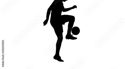 Fotografie Black silhouette of a professional soccer player juggling a ball.