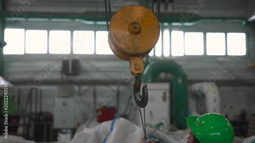 Personnel Examine Overhead Crane Systems To Ensure Industrial Safety Protocols Are Maintained . Media