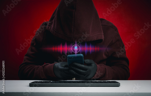 Konstfotografi AI voice scam concept with hooded hacker or scammer use smartphone and waveform interface