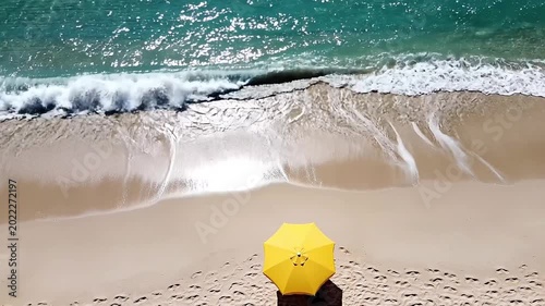 Aerial Drone View Of Yellow Beach Umbrella On Sandy Shore With Turquoise Waves