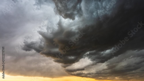 Moody dark clouds drifting across sky ahead of approaching storm