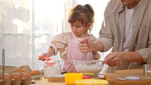 Billede på lærred Father helping their daughter knead dough to make bread