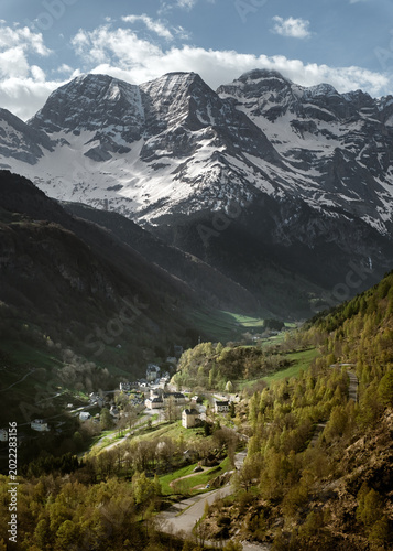 The village of Gavarnie stands below the snow covered Cirque de Gavarnie in the French Pyrenees