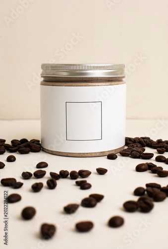 self care body cream coffee flavored surrounded by coffee beans on the beige background