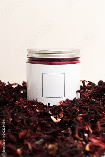 beauty products for skin care, bright bottles of dark red cream,  red tea flavors