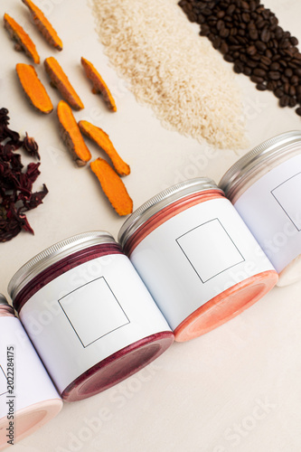 beauty products, a stack of body creams with different flavors on the beige background, coffee, rice, turmeric and red tea flavors