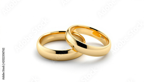 Two gold wedding rings on white background symbol of love.