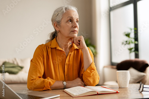 Senior woman contemplating, thinking during remote work at home