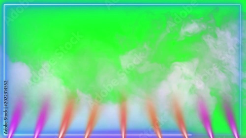 Dynamic stage lighting with colorful beams of pink and orange light illuminating swirling white smoke against a vibrant green screen background creating an energetic