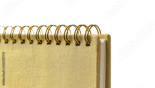 Bild auf Leinwand Isolated golden spiral notebook with textured fabric cover, ideal for notes and journaling