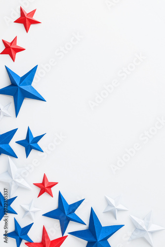 Red, white and blue origami paper stars on white background with large copy space, ideal for patriotic advertising, holiday promotions, greeting cards, invitations, banners, posters, social media