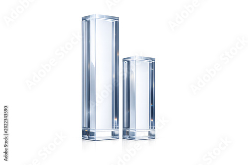 Two transparent hexagonal glass pillars of different heights stand side by side on a reflective surface against a solid white background.