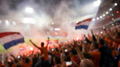 Intentationally blurred fans waving flags in a football stadium netherlands sports background