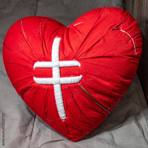 Plush red heart with white stitching