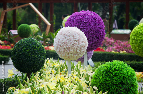 artifical flower topiaries in a garden in macau china on a sunny day.