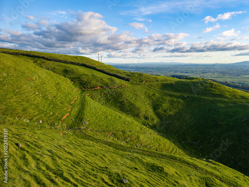 Lush farmland high in the Kaimai Range, New Zealand. The step-like ledges are 